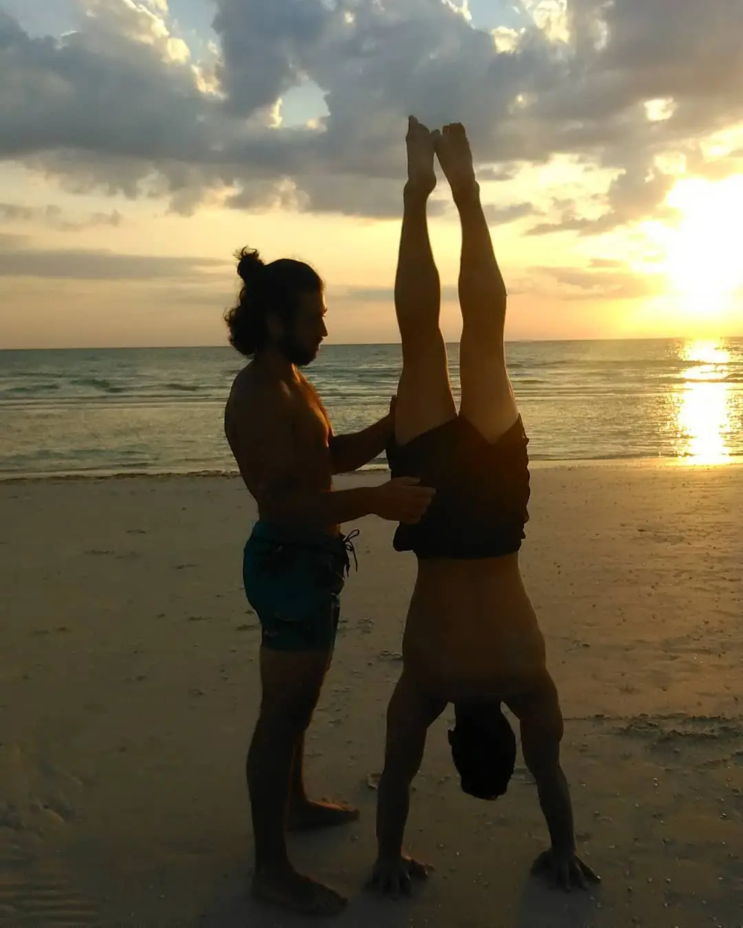 Spotting a handstand on the beach at sunset
